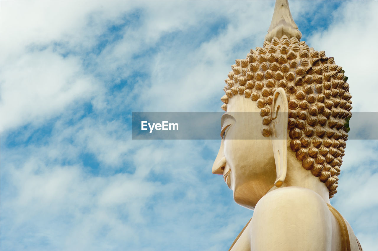 Low angle view of statue against temple against sky