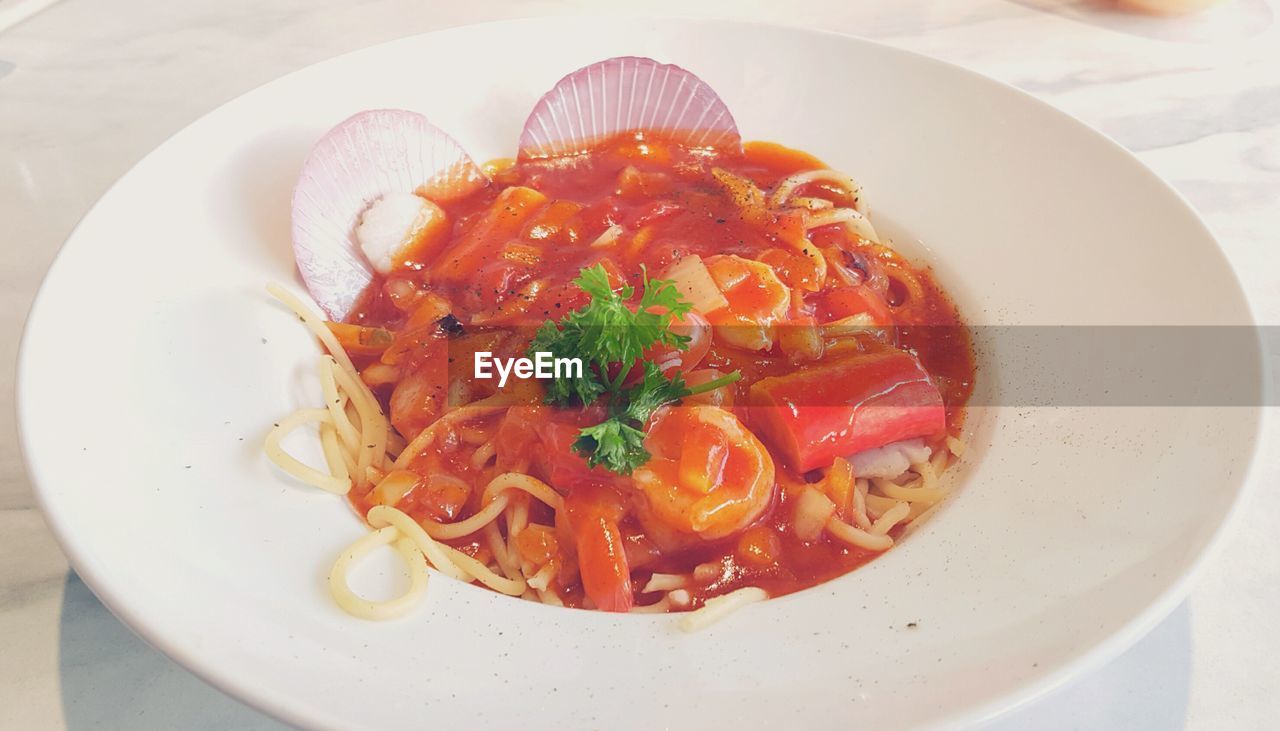 CLOSE-UP OF PASTA WITH SALAD IN PLATE