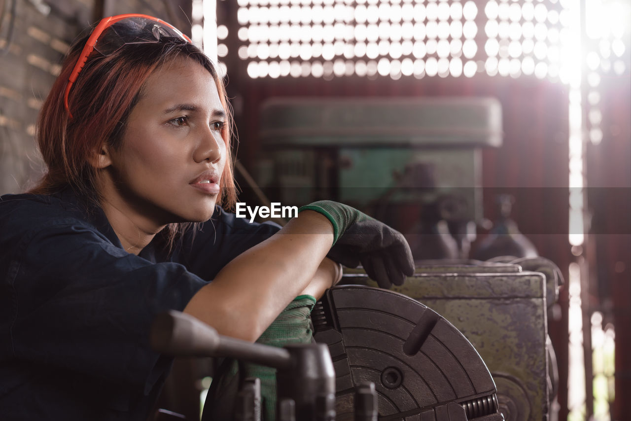 Thoughtful female mechanic at garage