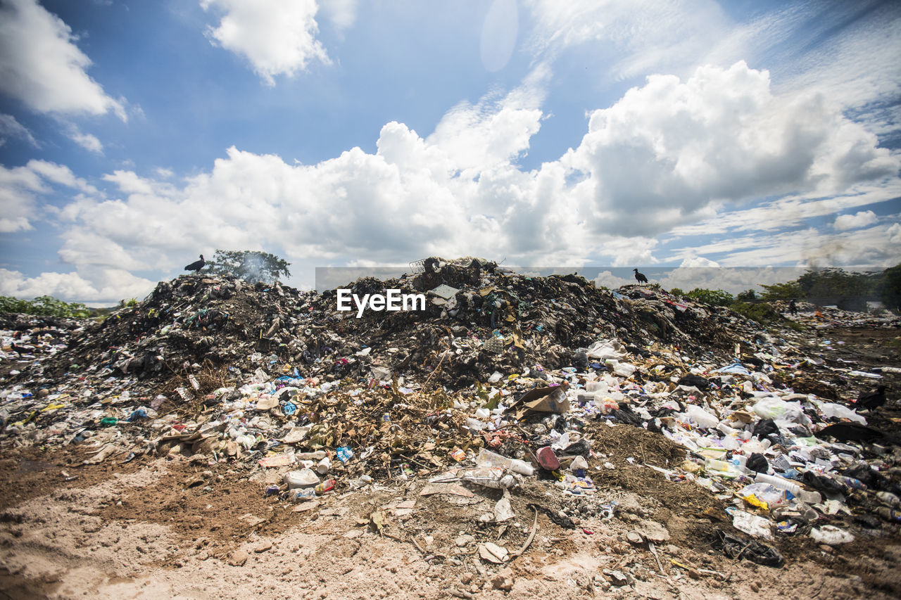 General view of rubbish piled on a landfill full of trash, burning.