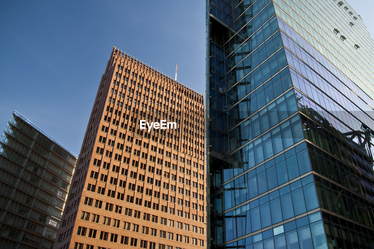 Low angle view of skyscrapers against clear sky