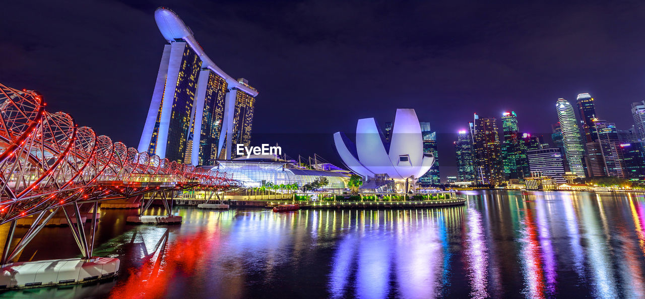 Illuminated modern buildings in city at night