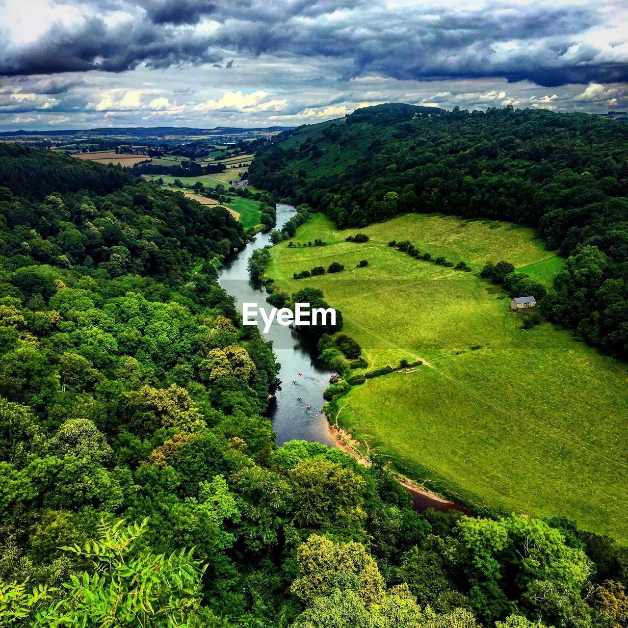 SCENIC VIEW OF RIVER WITH MOUNTAINS IN BACKGROUND