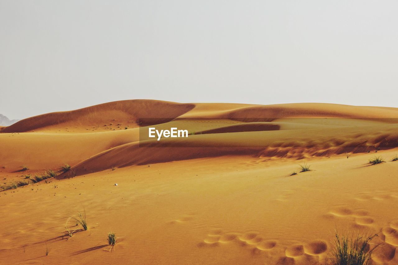 Scenic view of desert against clear sky