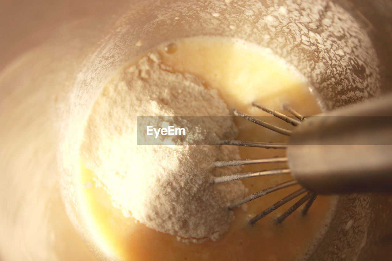 Close-up wire whisk in flour