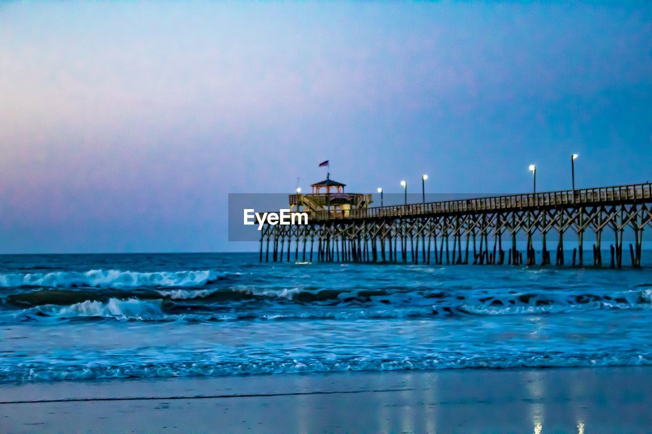 Pier over sea against sky