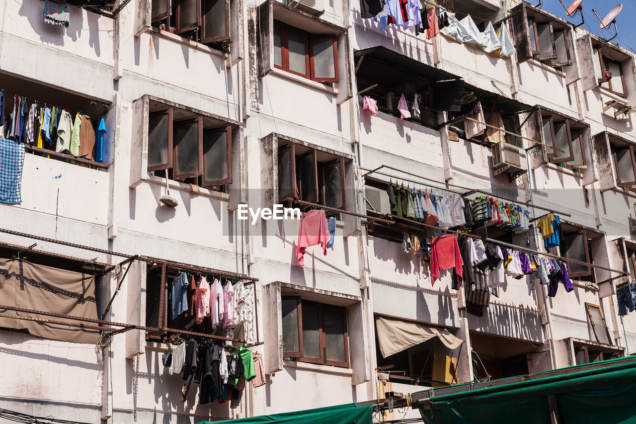 LOW ANGLE VIEW OF CLOTHES HANGING ON BUILDING