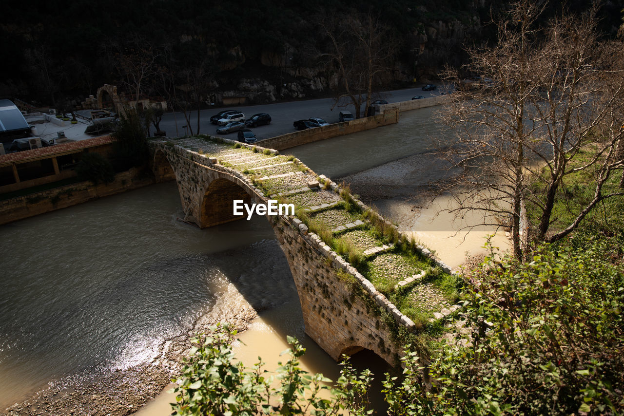 Medieval stone bridge arch over nahr al kalb river near beirut, lebanon, middle east