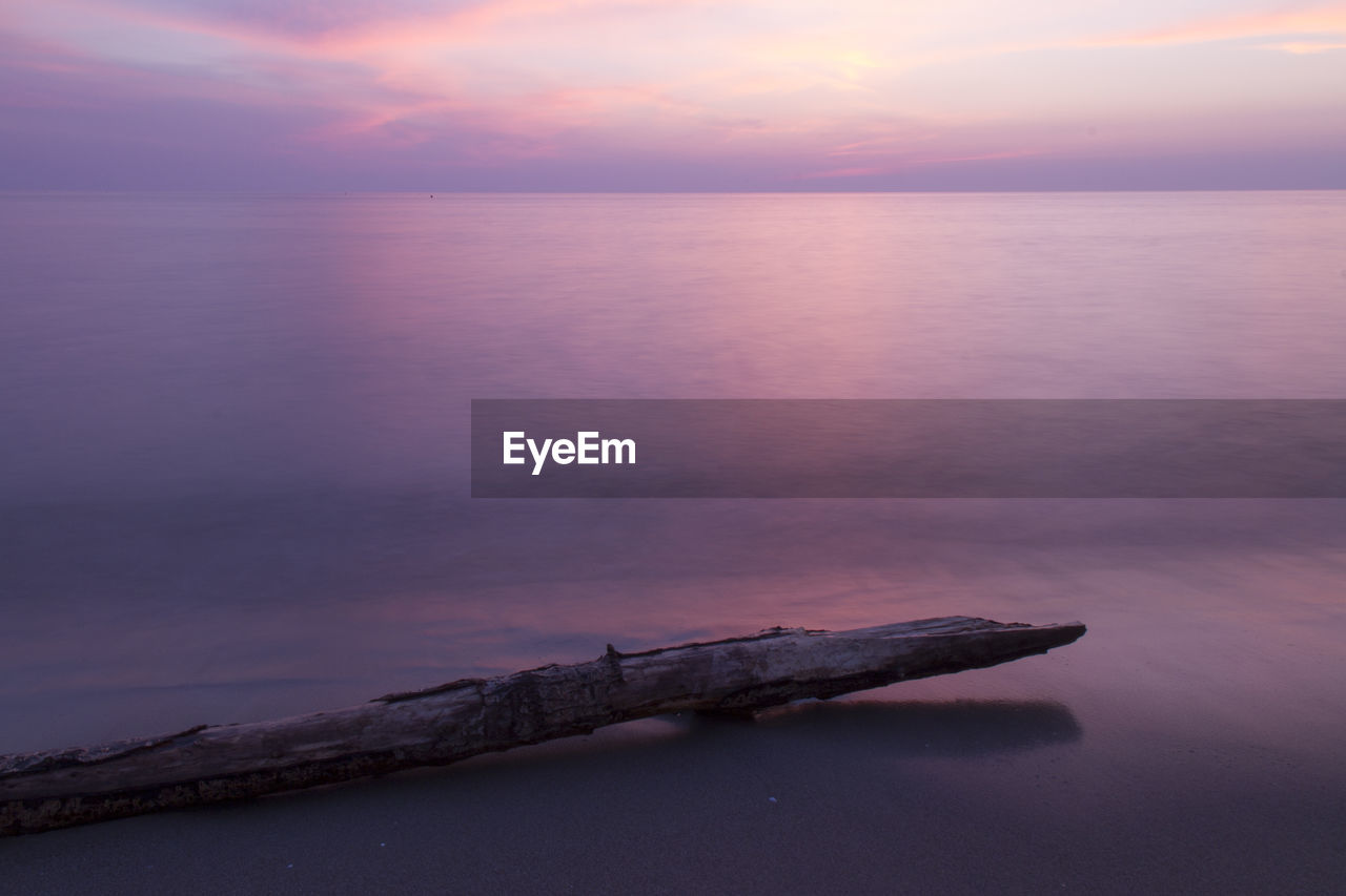 SCENIC VIEW OF SEA AGAINST ORANGE SKY