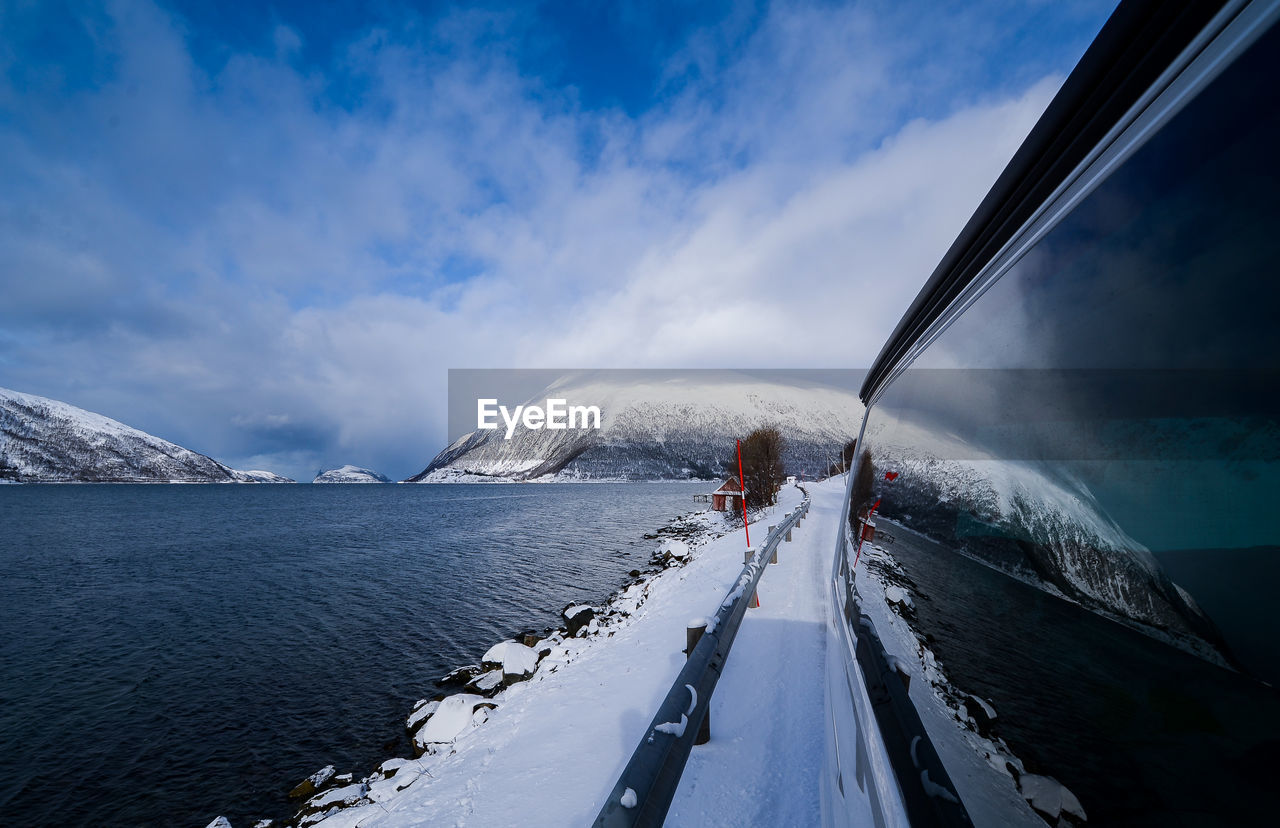 FROZEN LAKE AGAINST SKY