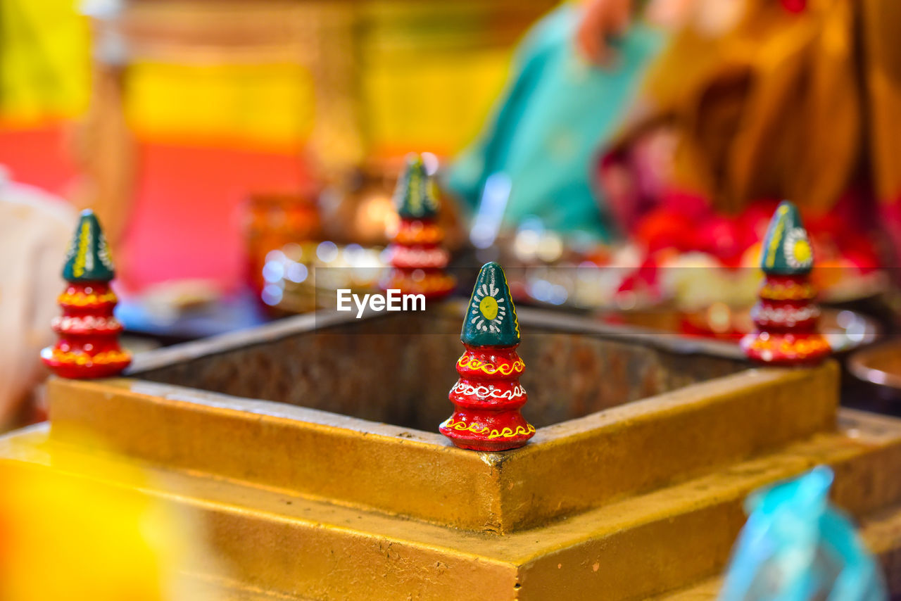 CLOSE-UP OF MULTI COLORED FIGURINE ON TABLE