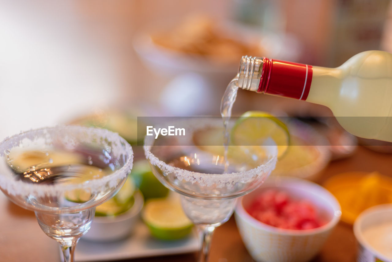 Pouring margarita into glass with salt on cinco de mayo