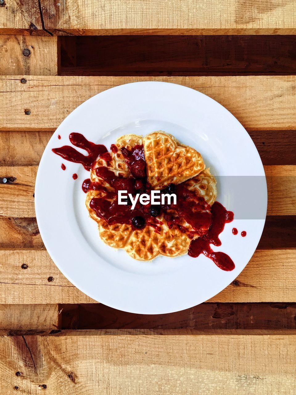High angle view of waffle served in plate on wooden table