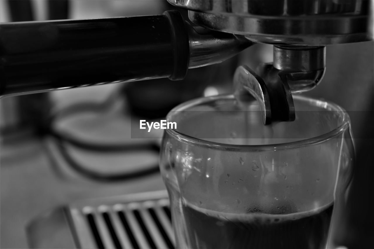 CLOSE-UP OF COFFEE CUP IN MACHINE