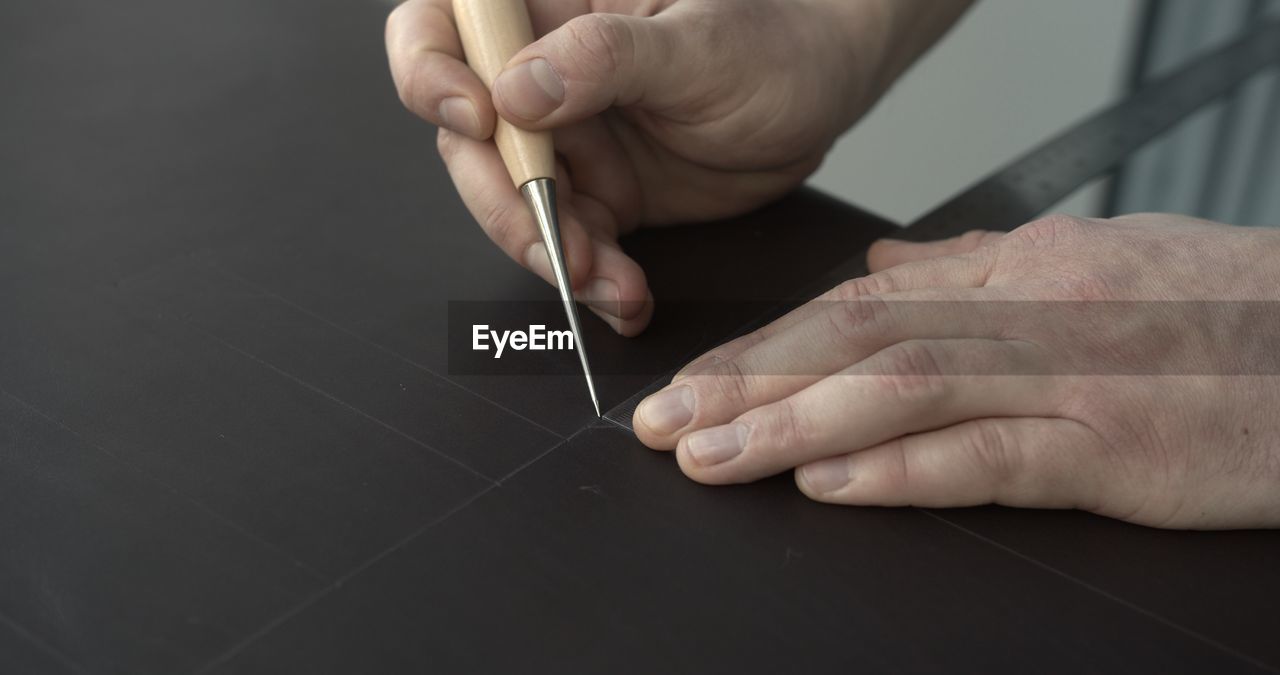 cropped hand of person working on table