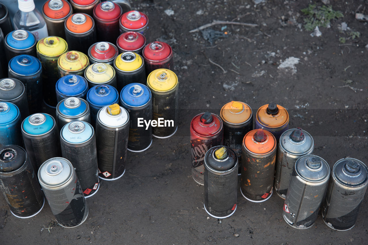 Close-up high angle view of spray cans