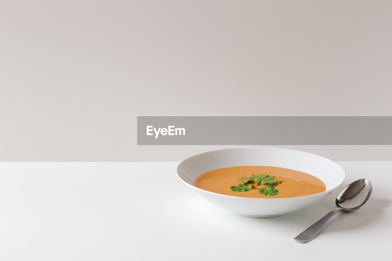 Creamy orange soup in simplistic setting