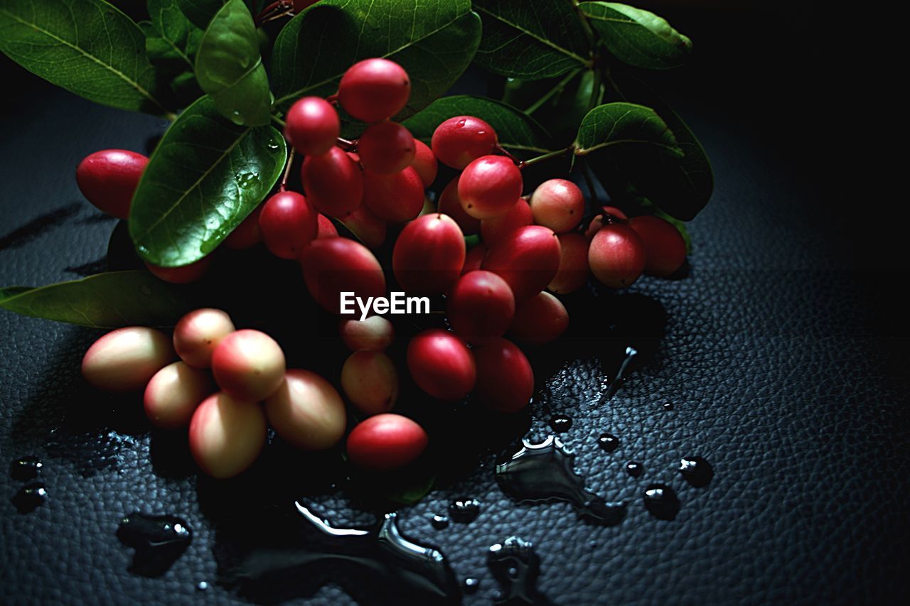 CLOSE-UP OF CHERRIES ON TABLE