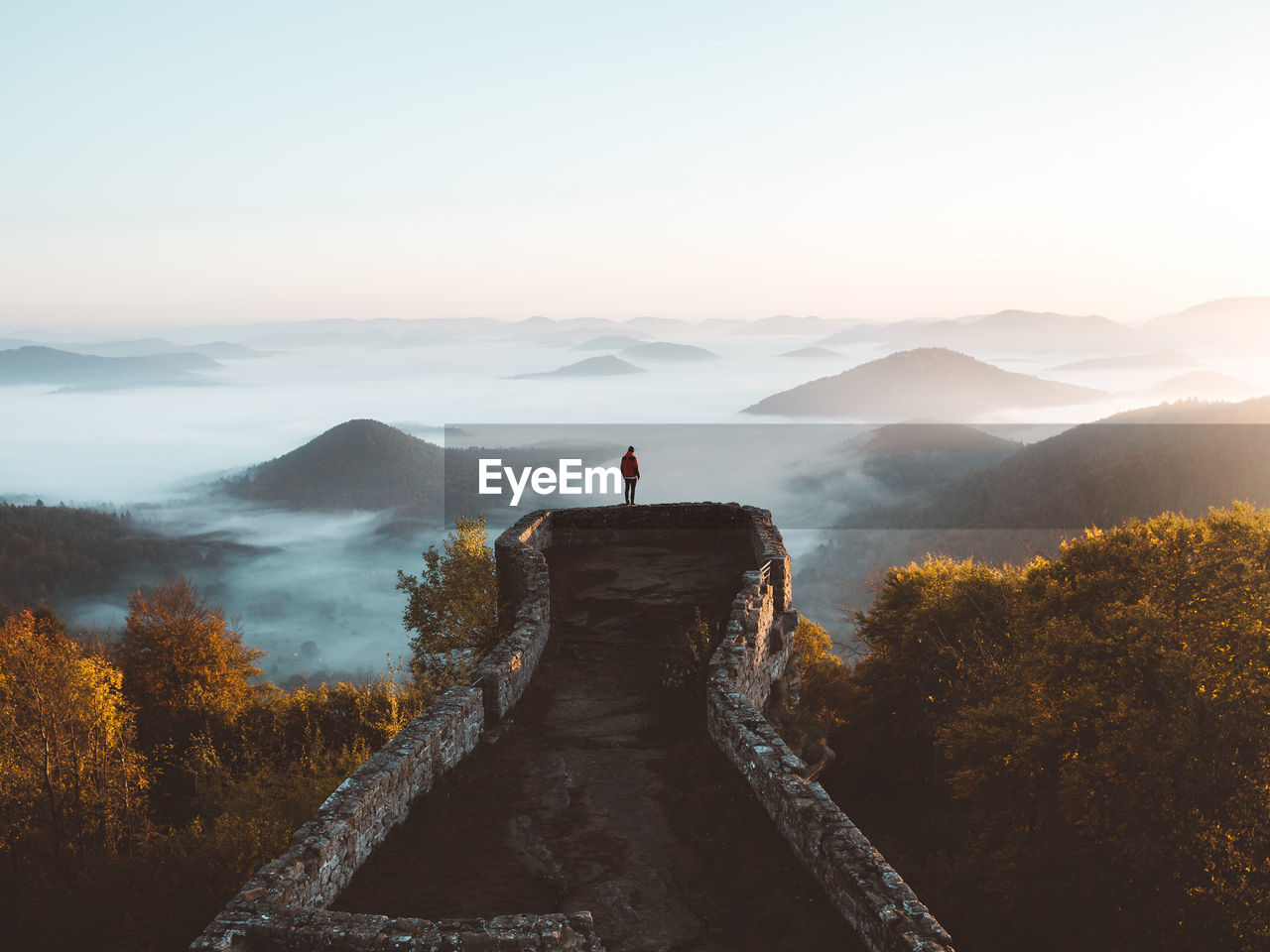 Man standing on mountain against sky