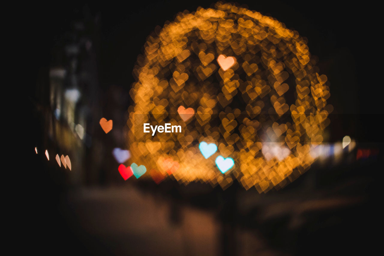 Defocused image of heart shape colorful illuminated lights at night