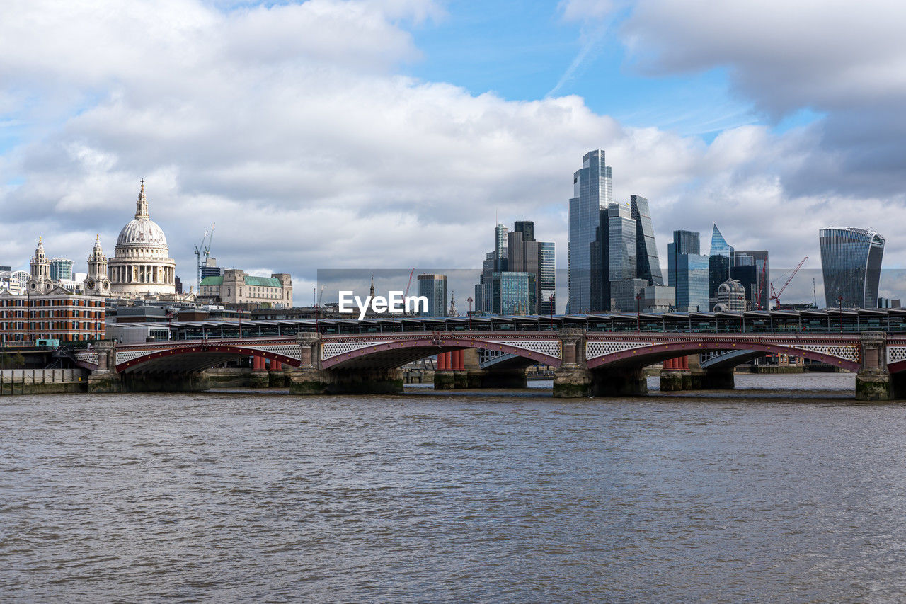 architecture, built structure, city, building exterior, bridge, sky, travel destinations, river, landscape, building, cityscape, skyline, landmark, water, urban skyline, cloud, transportation, travel, office building exterior, skyscraper, nature, city life, tourism, downtown district, no people, urban area, tower, waterway, waterfront, outdoors, reflection, residential district, downtown, day, office, street, environment, horizon, harbor