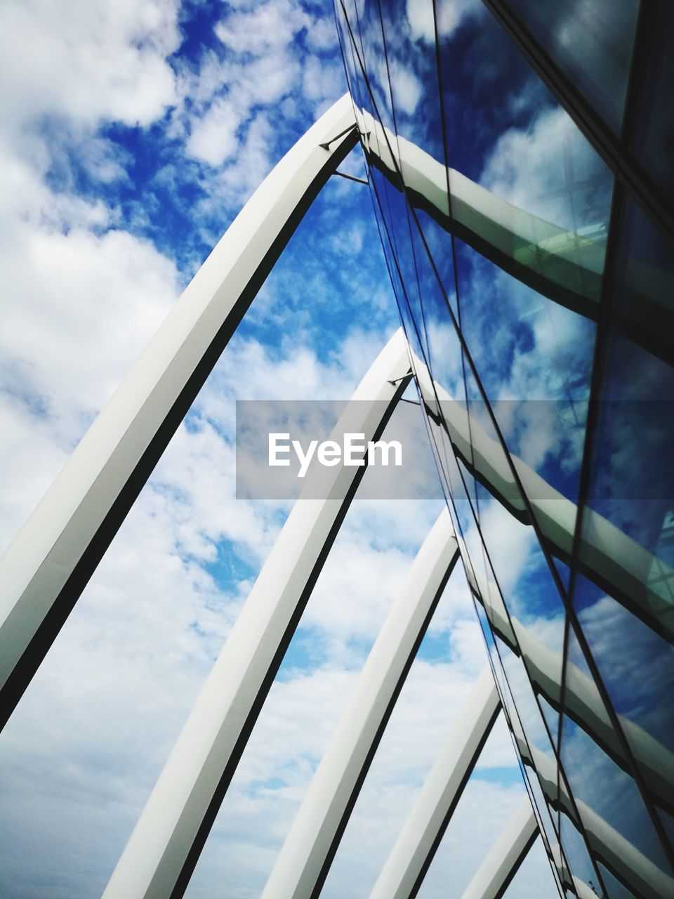 LOW ANGLE VIEW OF CLOUDY SKY SEEN THROUGH WINDOW