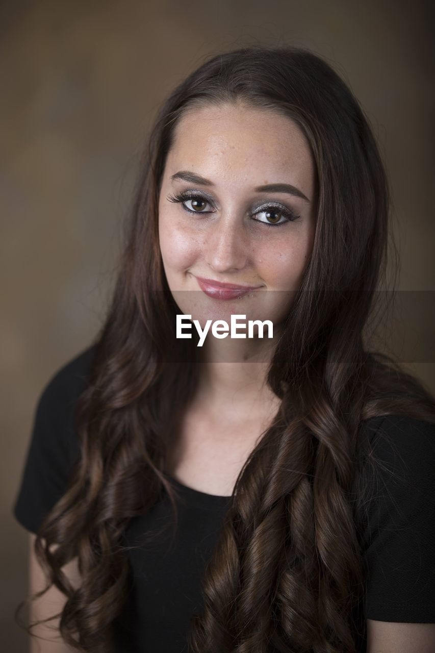 portrait, long hair, human hair, hairstyle, looking at camera, one person, brown hair, women, adult, smiling, human face, headshot, young adult, indoors, eyebrow, studio shot, happiness, front view, portrait photography, person, fashion, emotion, brown eyes, black hair, female, clothing, individuality, layered hair, close-up, photo shoot, make-up, cheerful, gray