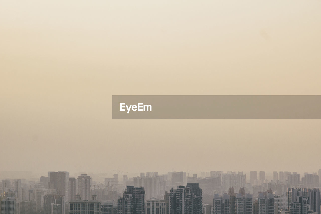 High angle view of buildings in city against clear sky