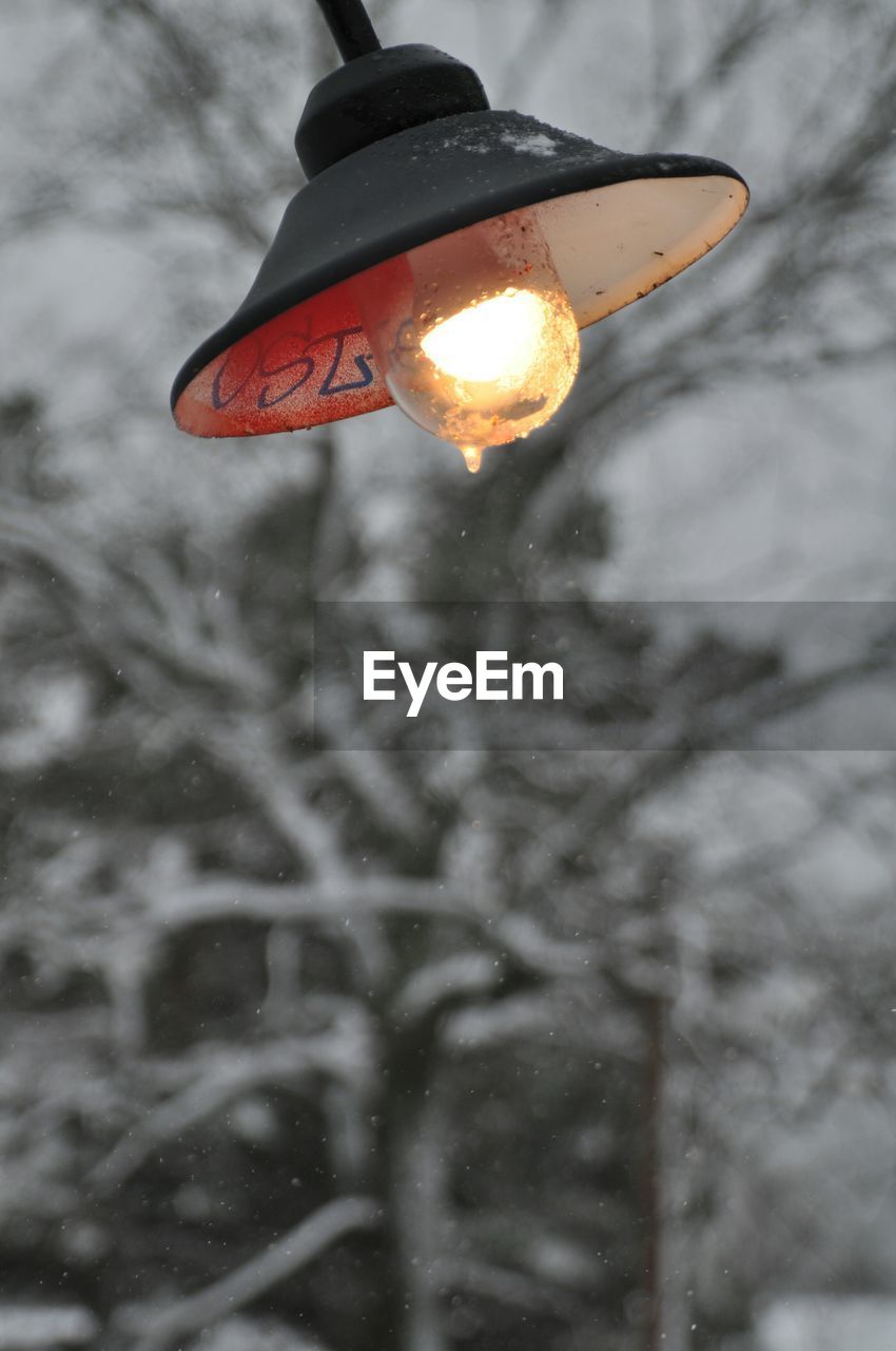 Close-up of hanging light against blurred background