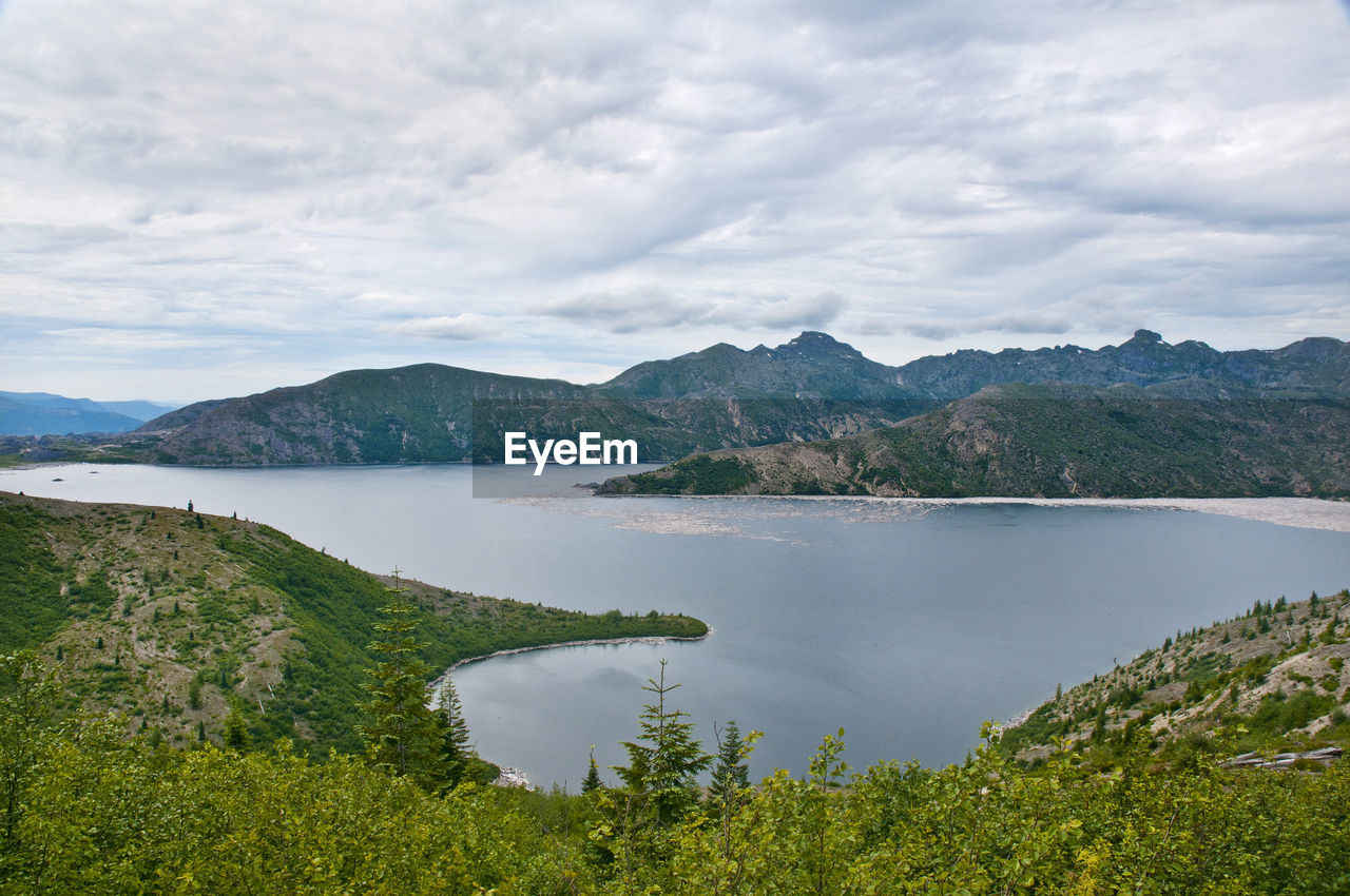 Scenic view of lake and mountains against sky