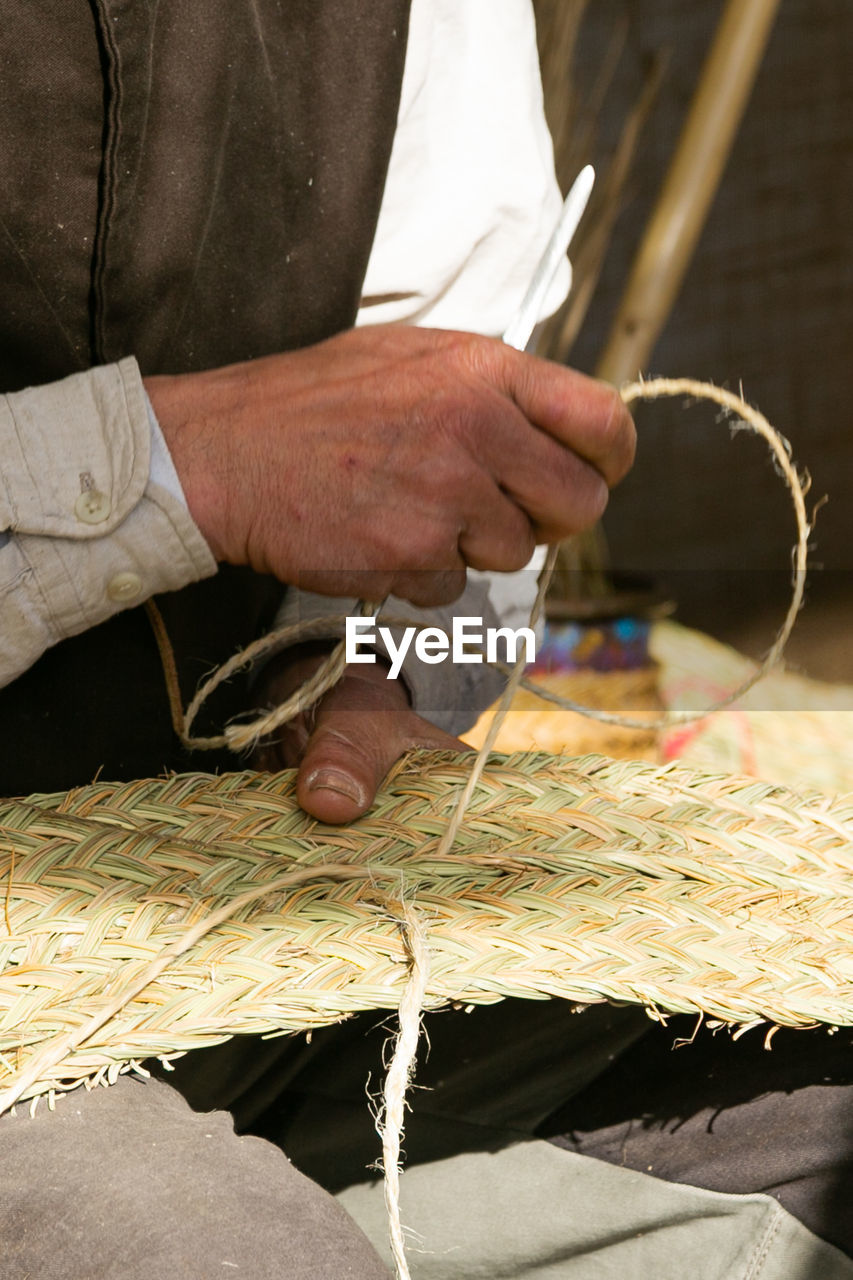 Craftsman's hands, working the esparto grass, handicrafts in the street