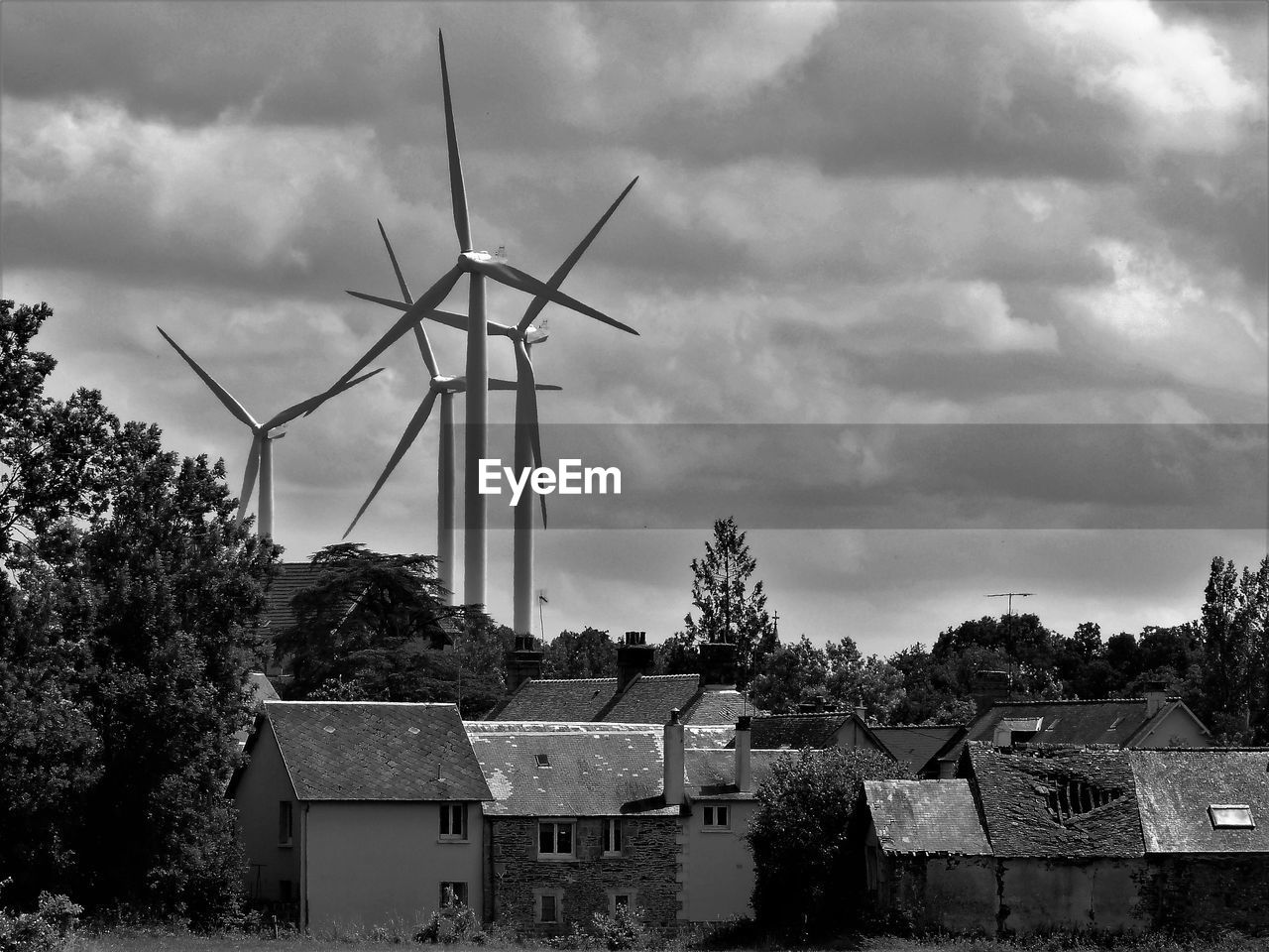 WIND TURBINES BY BUILDING AGAINST SKY