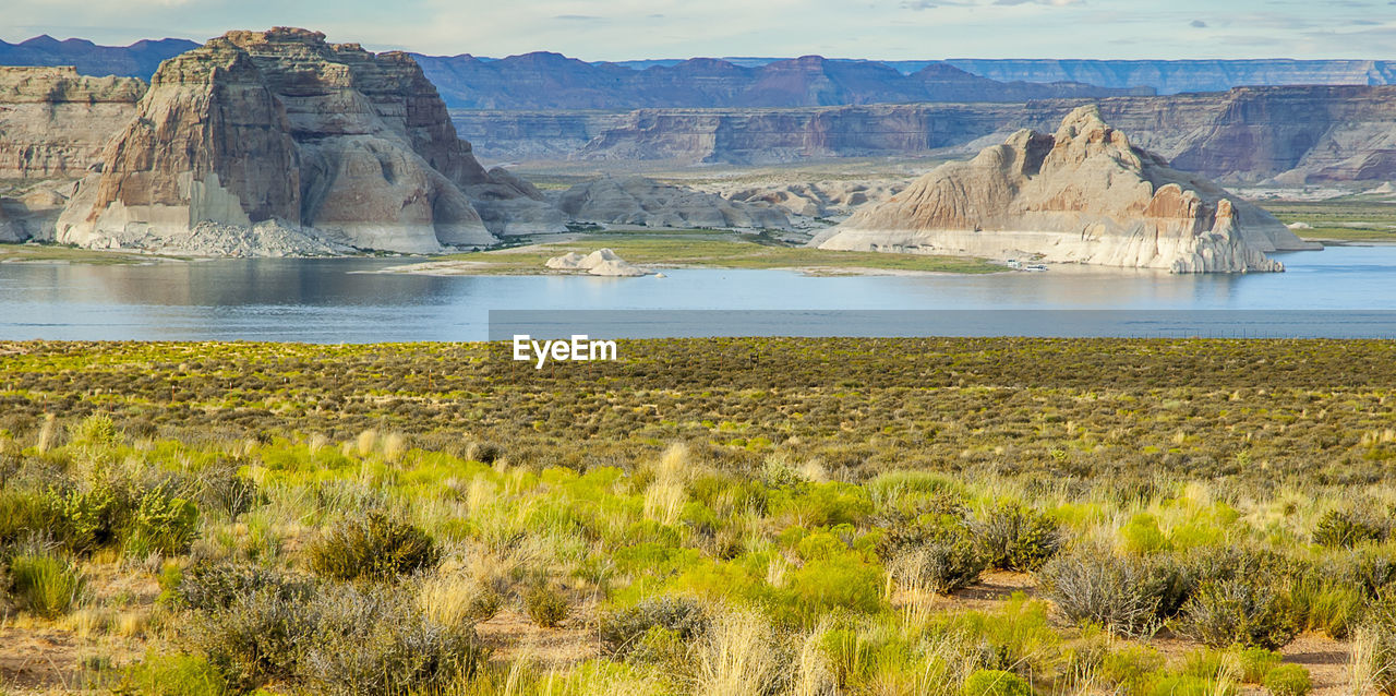 SCENIC VIEW OF LAND AND MOUNTAINS AGAINST ROCK FORMATION