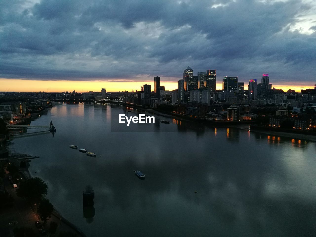 View of river against cloudy sky at sunset