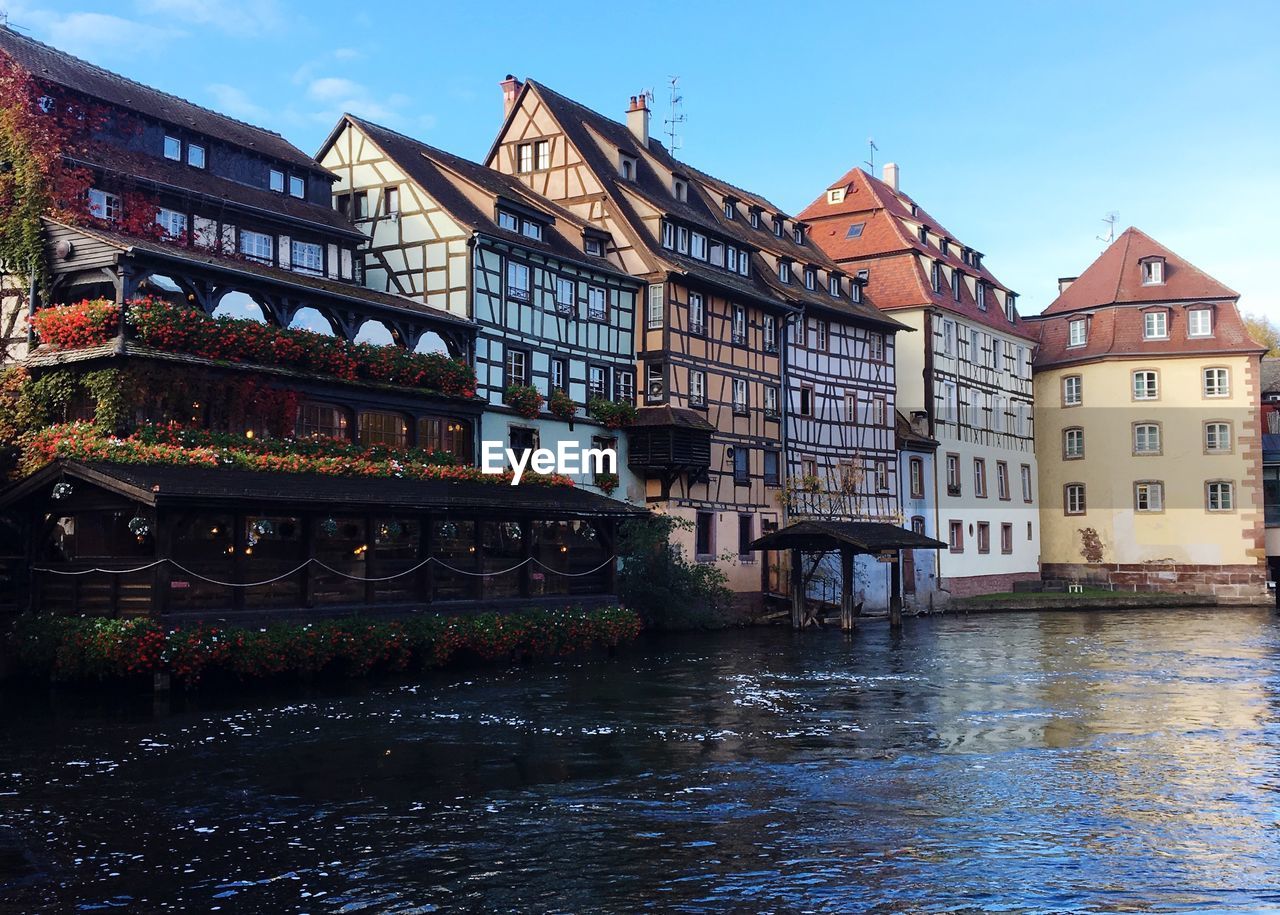 Bridge over river against buildings in city