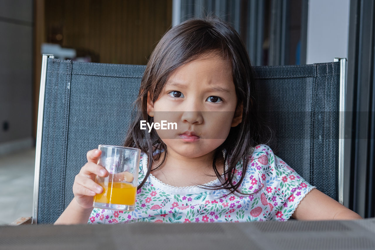 Portrait of girl drinking juice