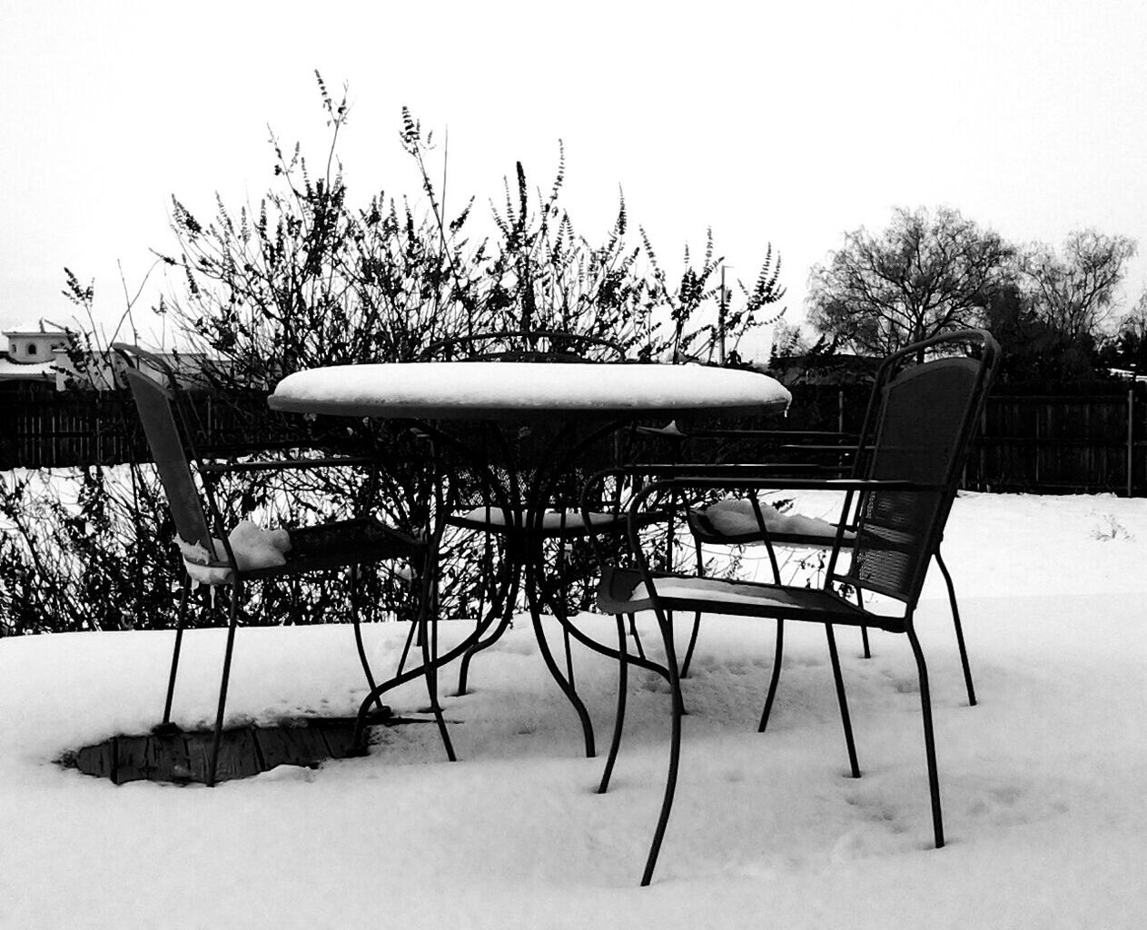 Chairs and table on snow covered yard