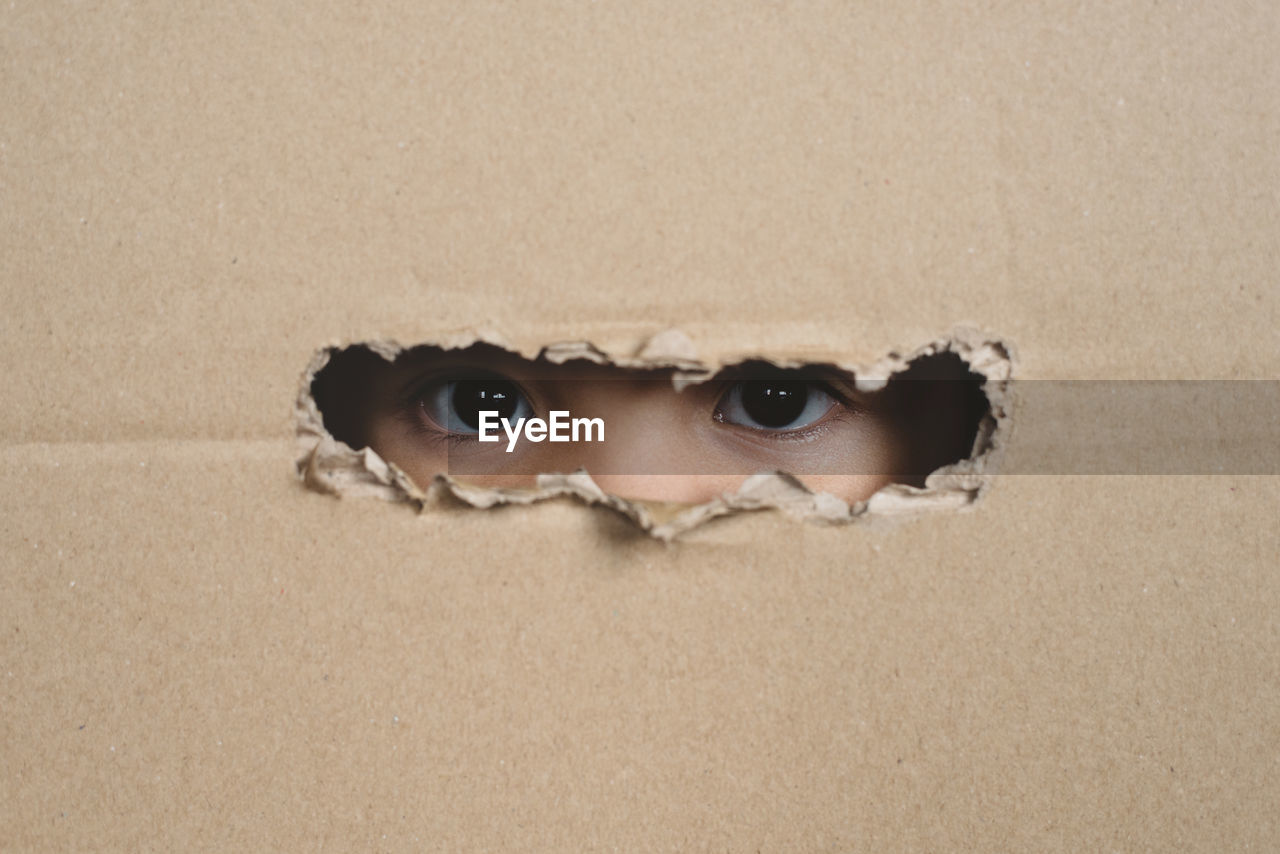 Close-up portrait of serious young man with hole