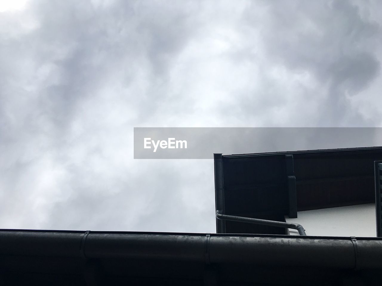 Low angle view of house against cloudy sky