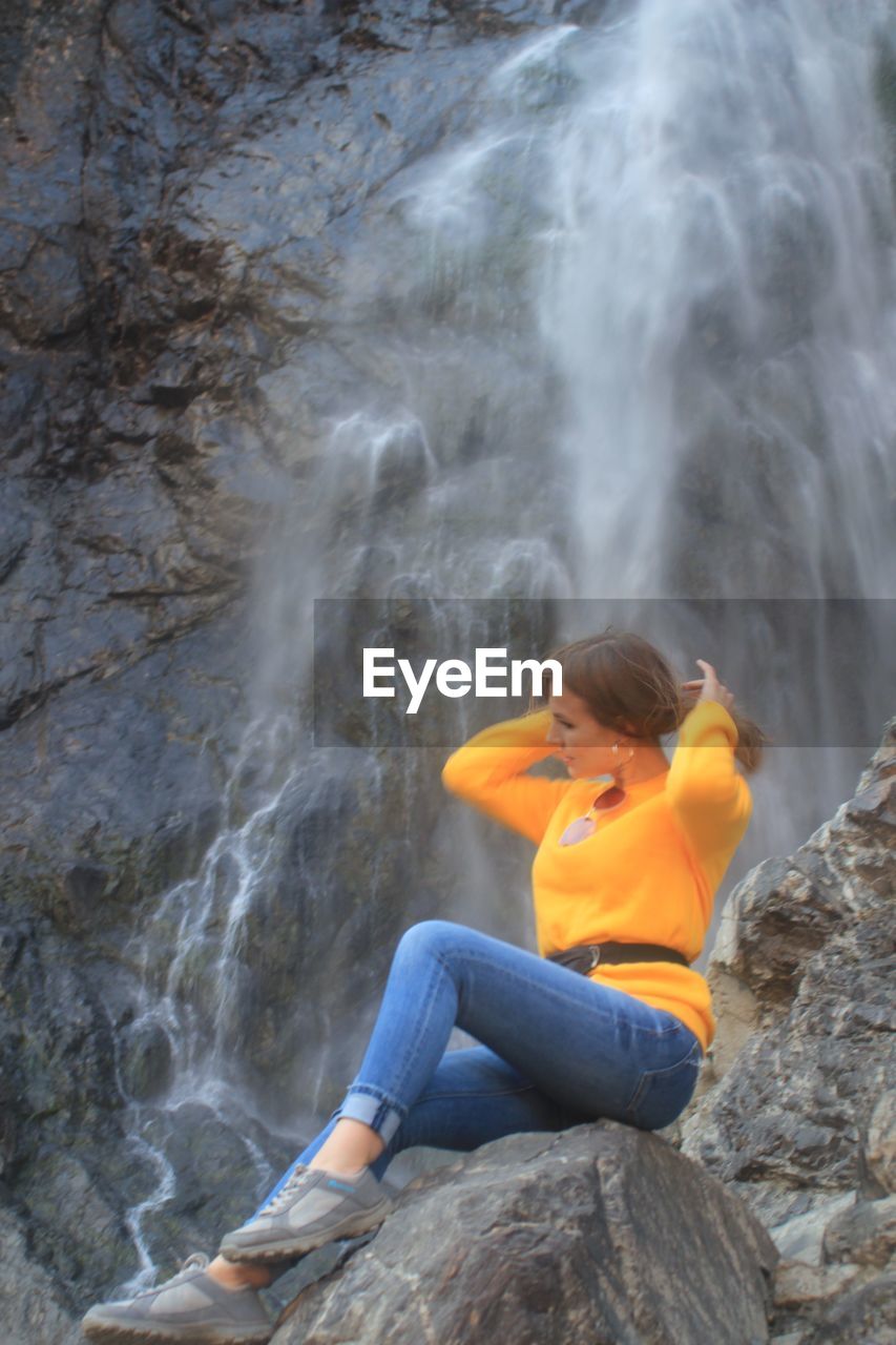 MAN SITTING ON ROCK