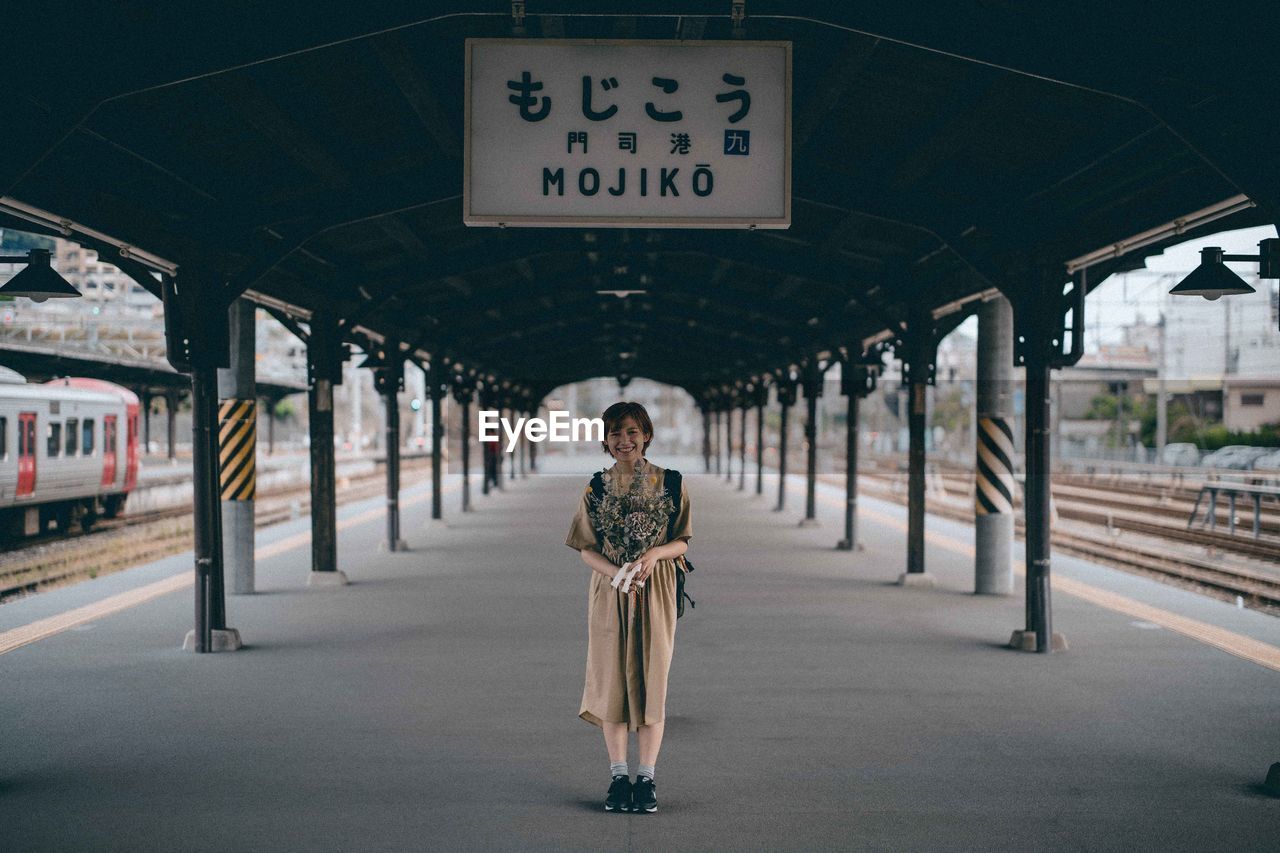 PORTRAIT OF MAN ON RAILROAD STATION