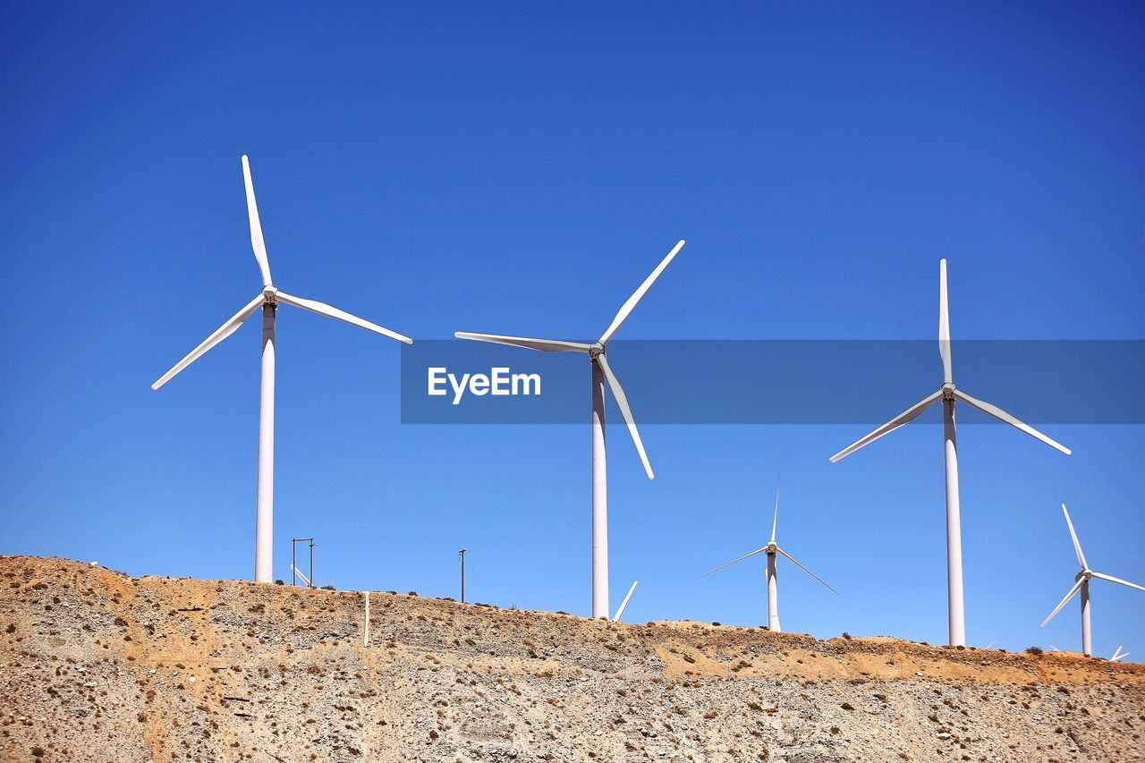 LOW ANGLE VIEW OF WIND TURBINES