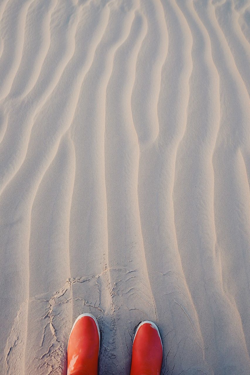 Low section of person on sand