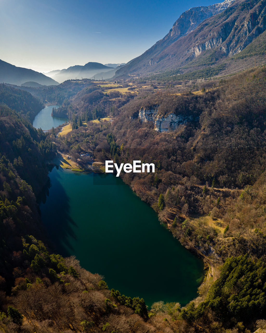 High angle view of lake and mountains against sky