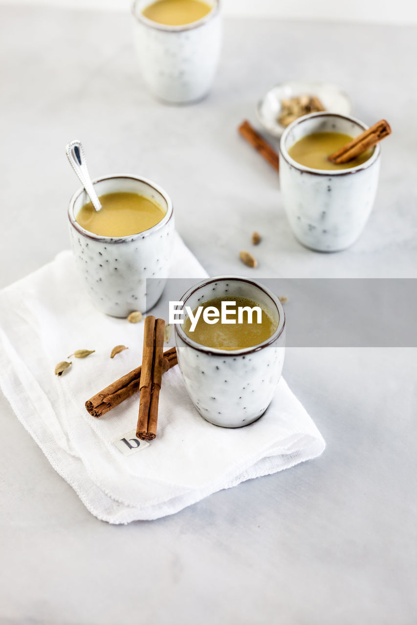 HIGH ANGLE VIEW OF COFFEE CUP AND TEA ON TABLE