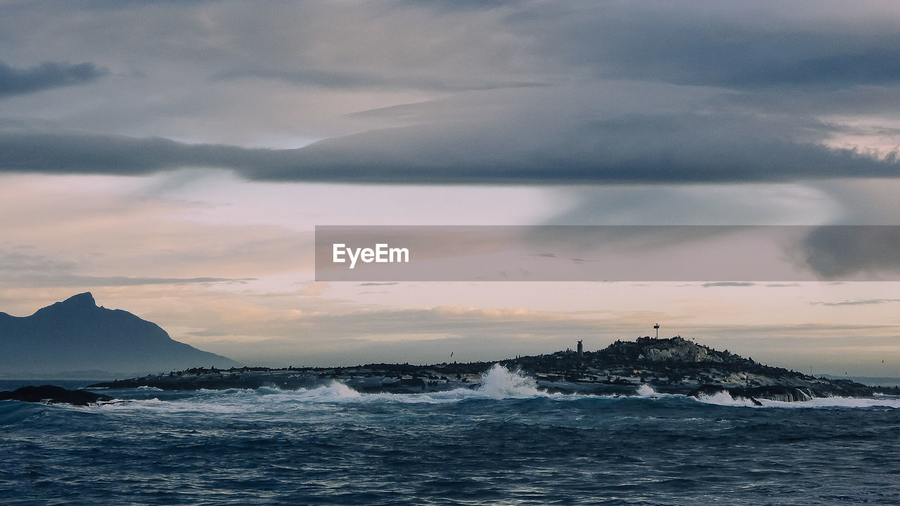 Scenic view of sea and mountains during sunset