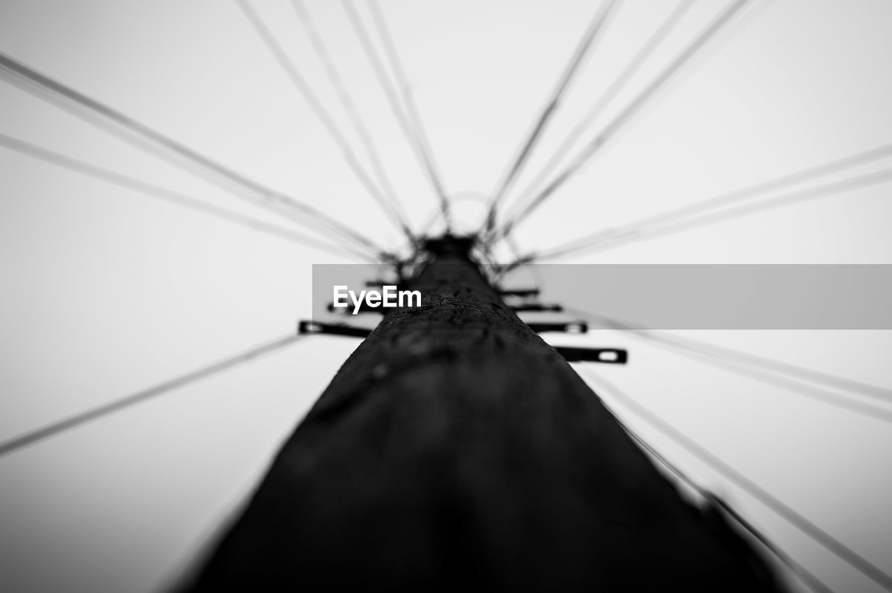 LOW ANGLE VIEW OF CABLES AGAINST SKY
