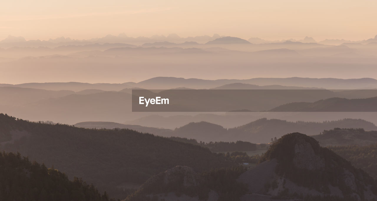 scenic view of mountains against sky at sunset