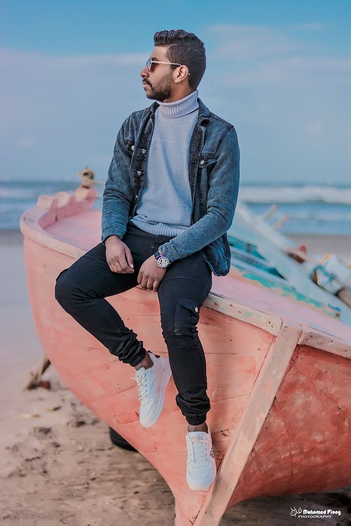 YOUNG MAN LOOKING AT BEACH