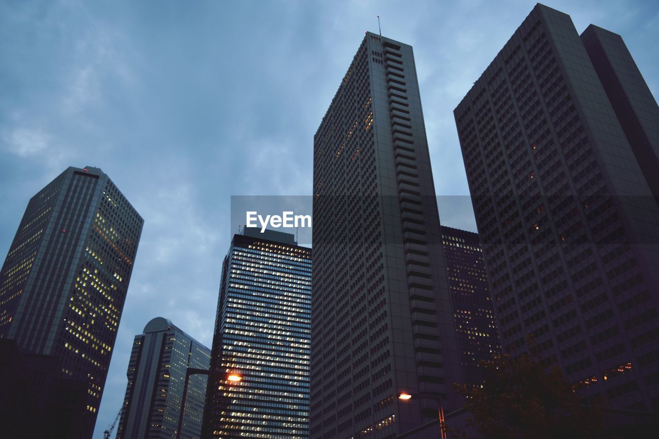 Low angle view of modern buildings against sky at dusk